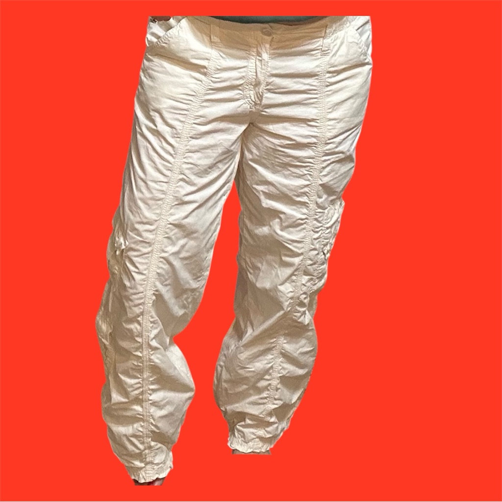 Cream low-rise cargo trousers with a gathered hem photographed against a red background